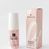 Small bottle of nail glue with a precision brush applicator, designed for securing press-on nails and providing long-lasting hold.