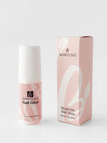 Small bottle of nail glue with a precision brush applicator, designed for securing press-on nails and providing long-lasting hold.